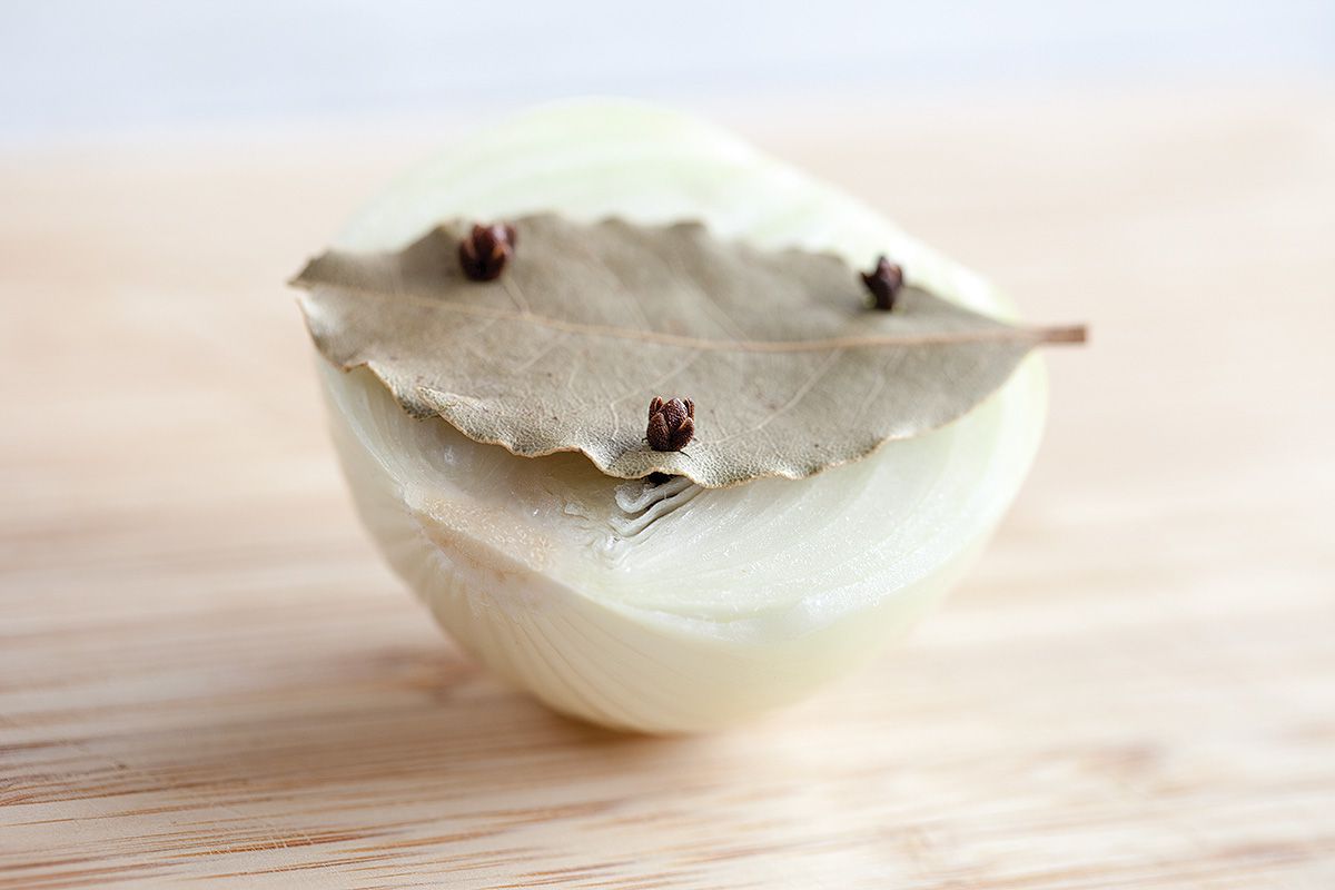 Bay leaf pinned by cloves on an onion
