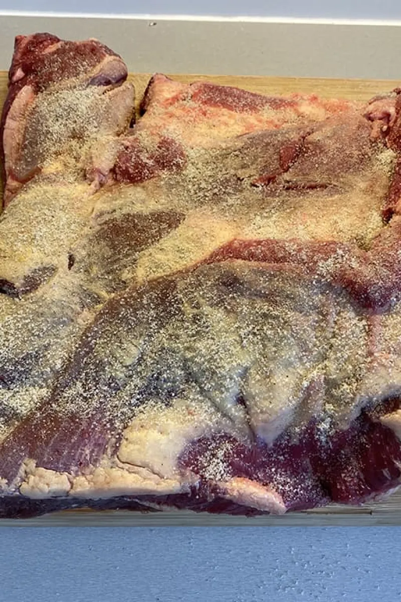 Cover the brisket with salt and pepper
