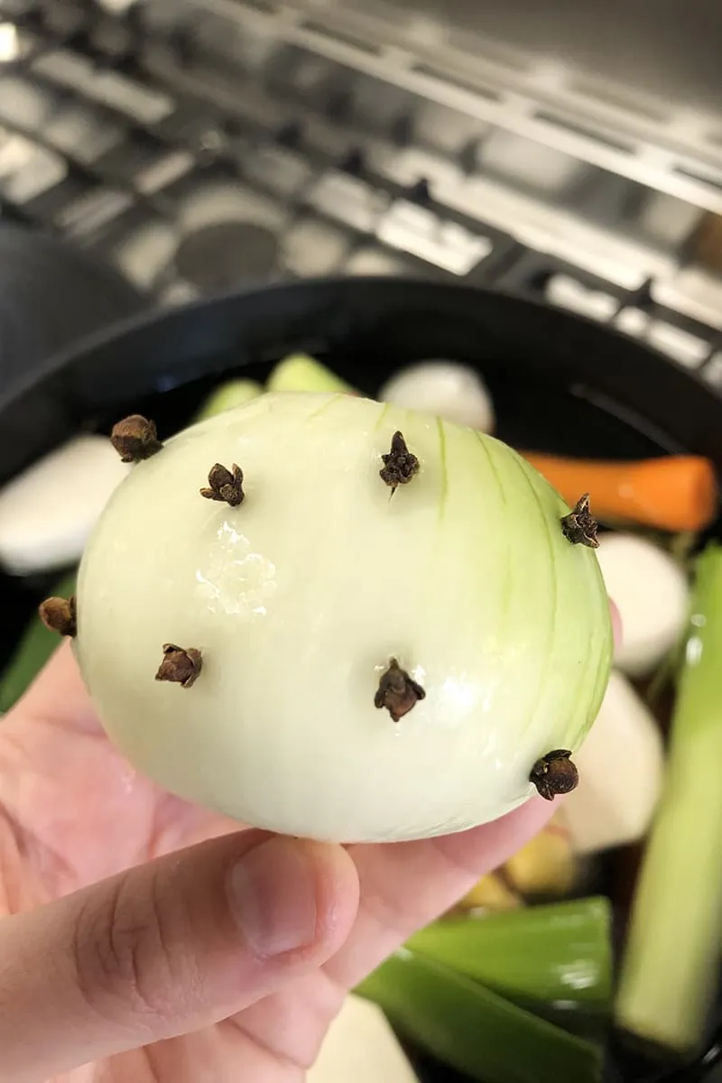 Onion with cloves stuck on it