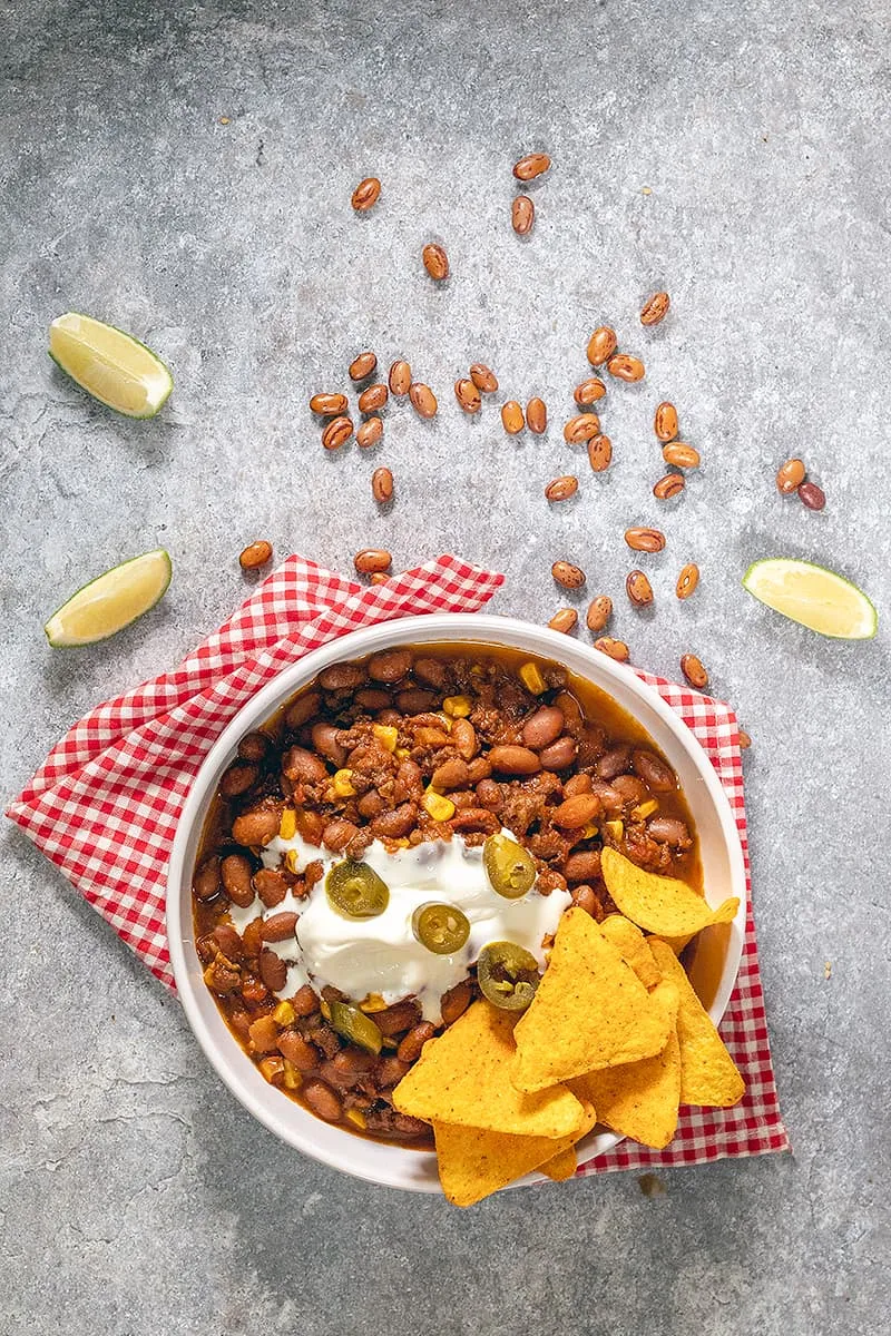 Hearty mexican bean stew with minced meat and corn