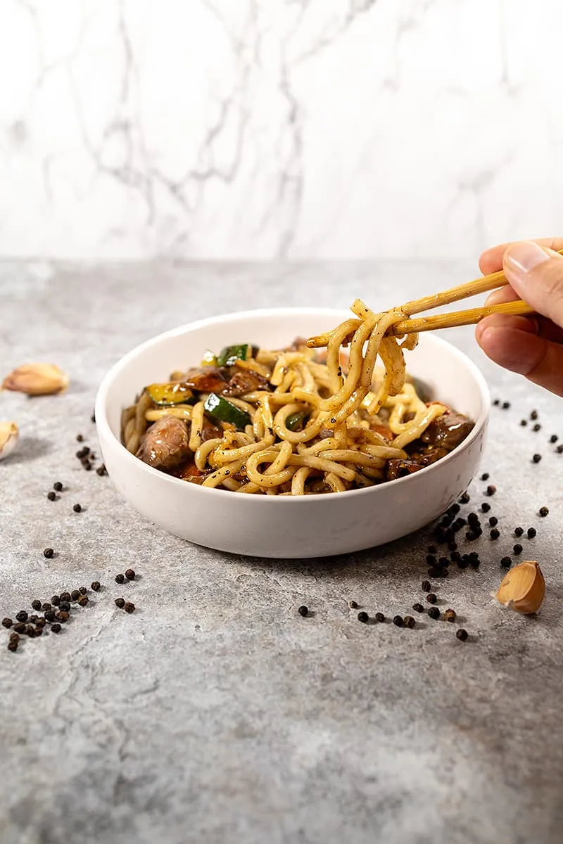 Japanese udon noodles with black pepper wok sauce