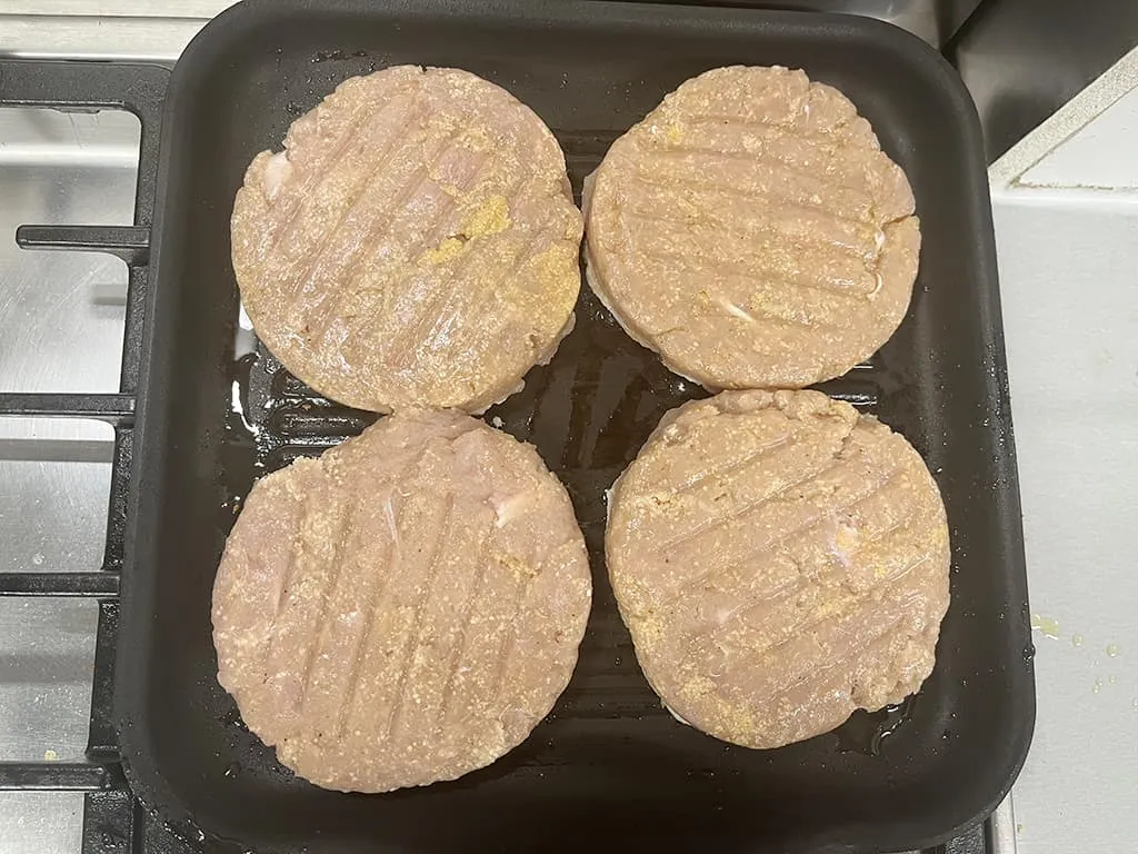 Grilling turkey burger with cheese sauce
