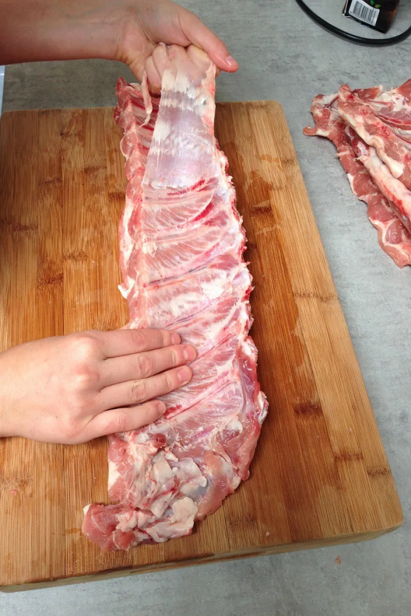 Removing the membrane from a rack of spare ribs