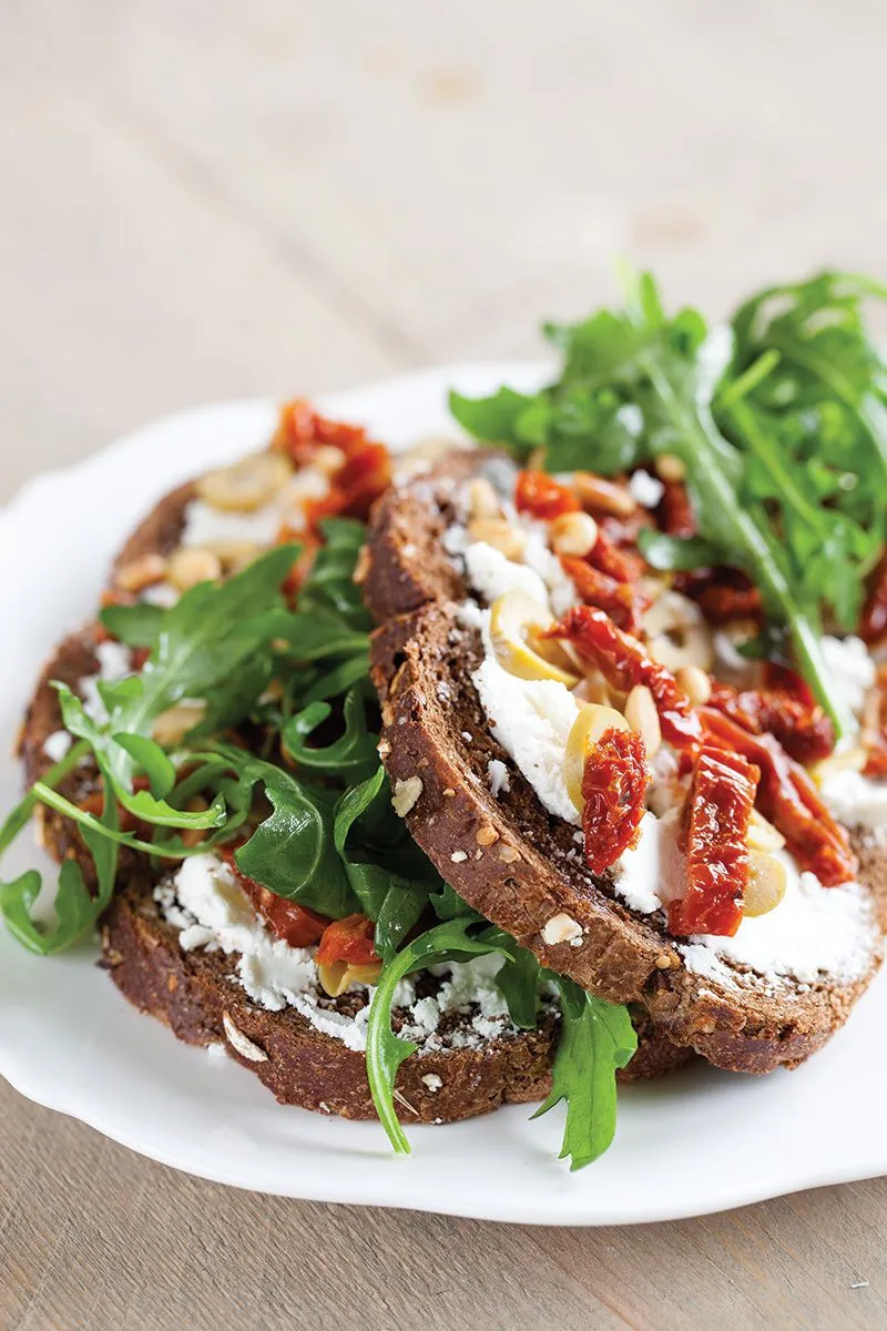 Goat cheese, sun-dried tomato and olive open sandwich