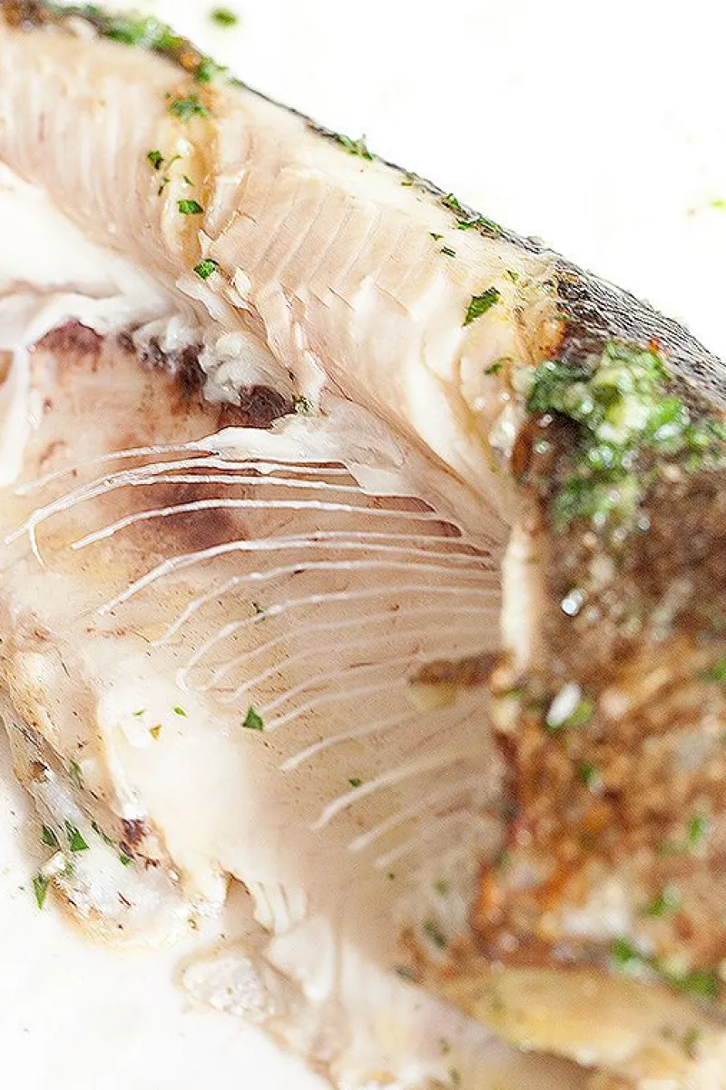 A well-cooked trout with herb butter