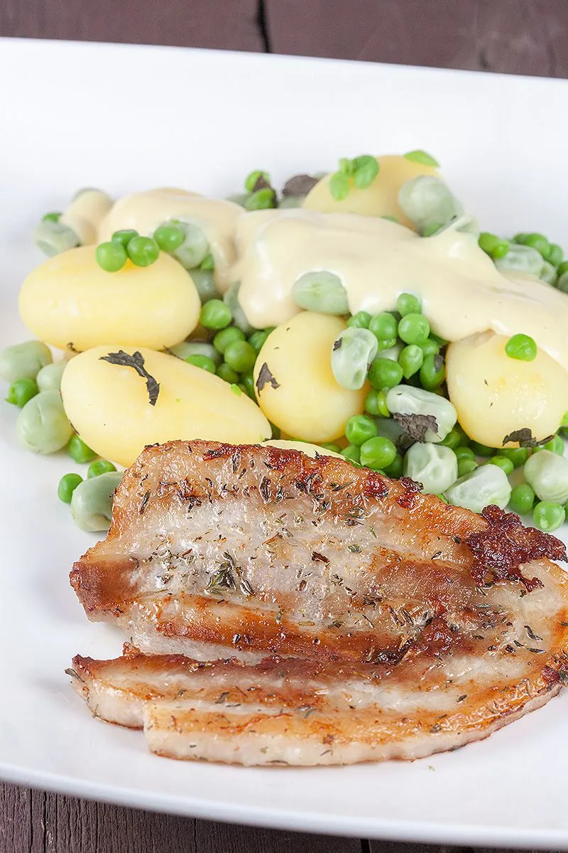 Pork belly slices and broad bean potato salad