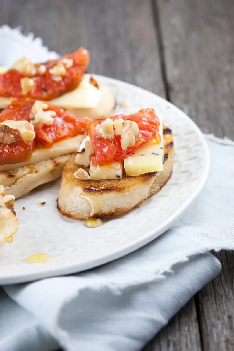 Truffle cheese and grapefruit crostini