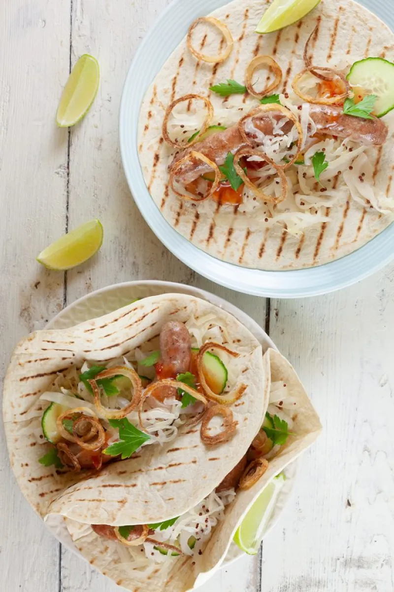 Tortillas with sausages, white cabbage and crispy onions