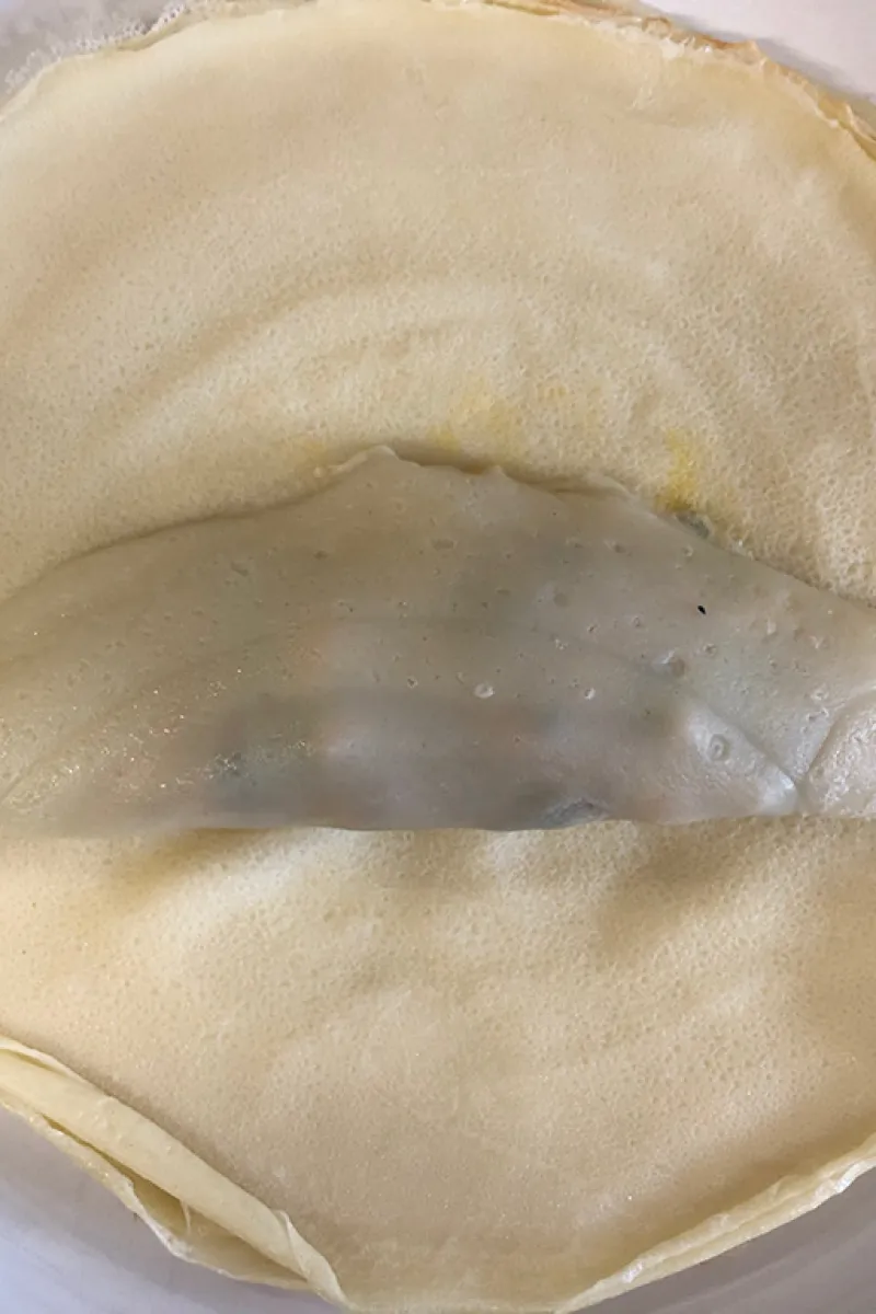 Folding the ham and chicken lumpia