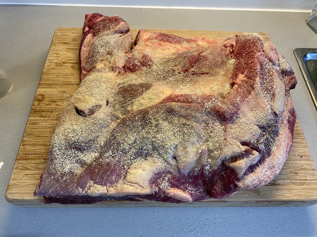 Cover the brisket with salt and pepper