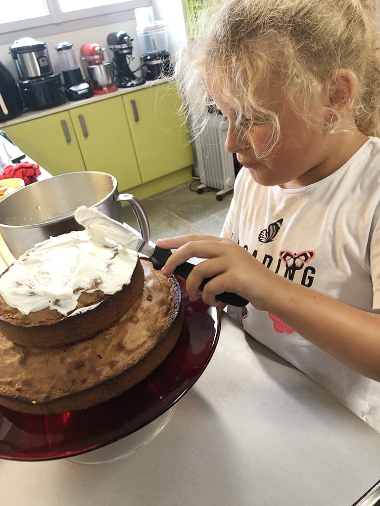 Niece Tessel ‘sticks’ the cakes together using whipped cream