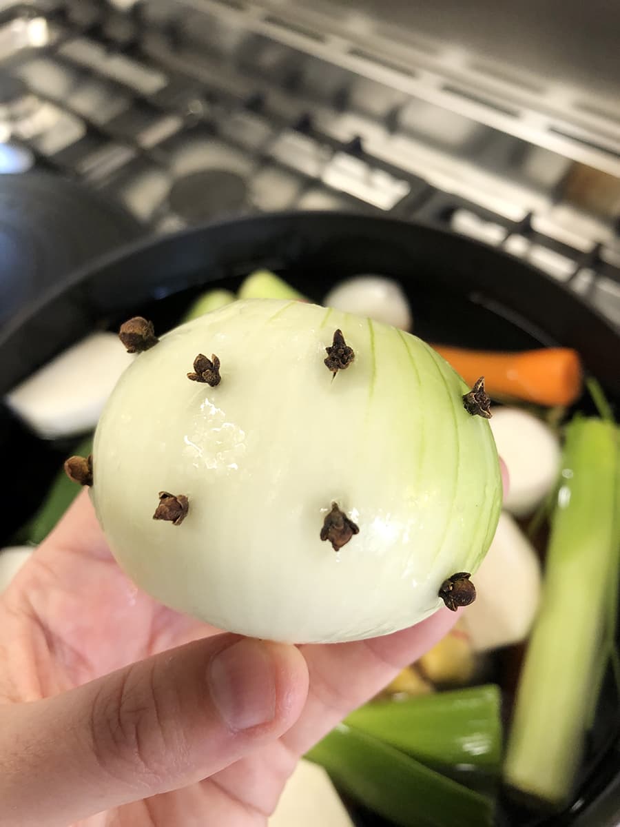 Onion with cloves stuck on it