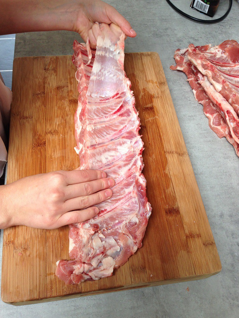 Removing the membrane from a rack of spare ribs