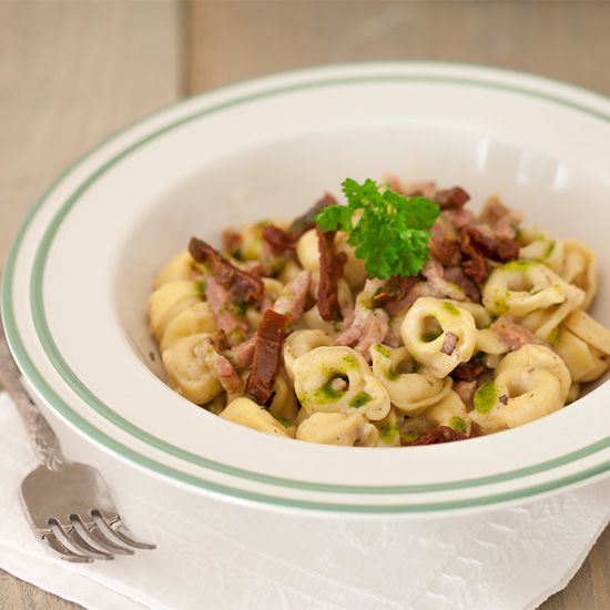 Cheese tortellini with bacon and herb oil