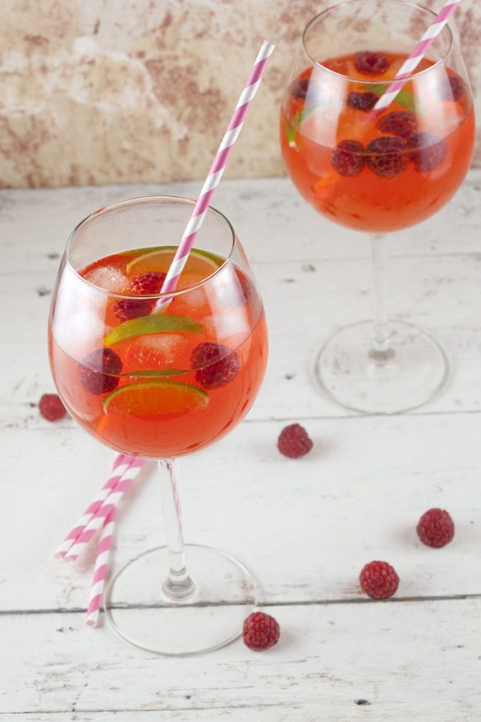 Aperol cocktail with lime and raspberries
