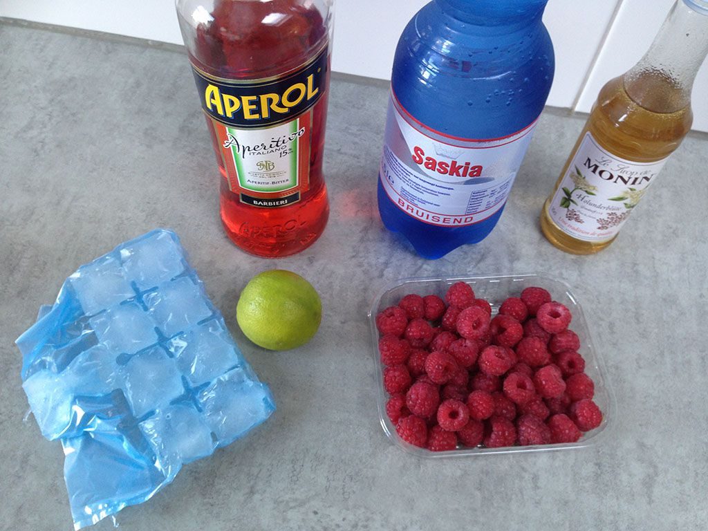 Aperol cocktail with lime and raspberries ingredients