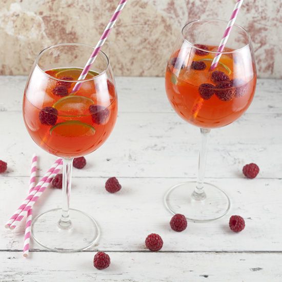 Aperol cocktail with lime and raspberries
