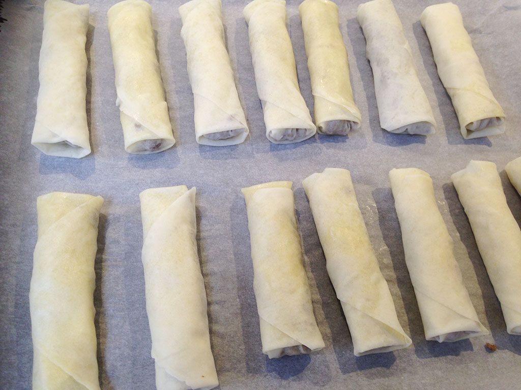 Folding spiced ground beef phyllo dough rolls