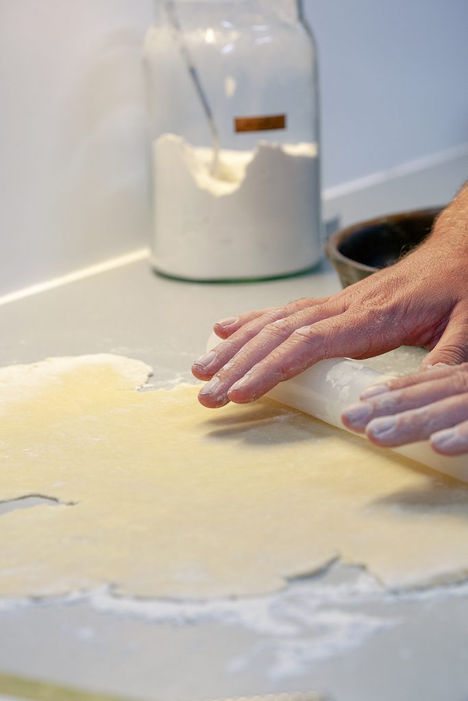 Rolling out homemade savoury shortcrust pastry